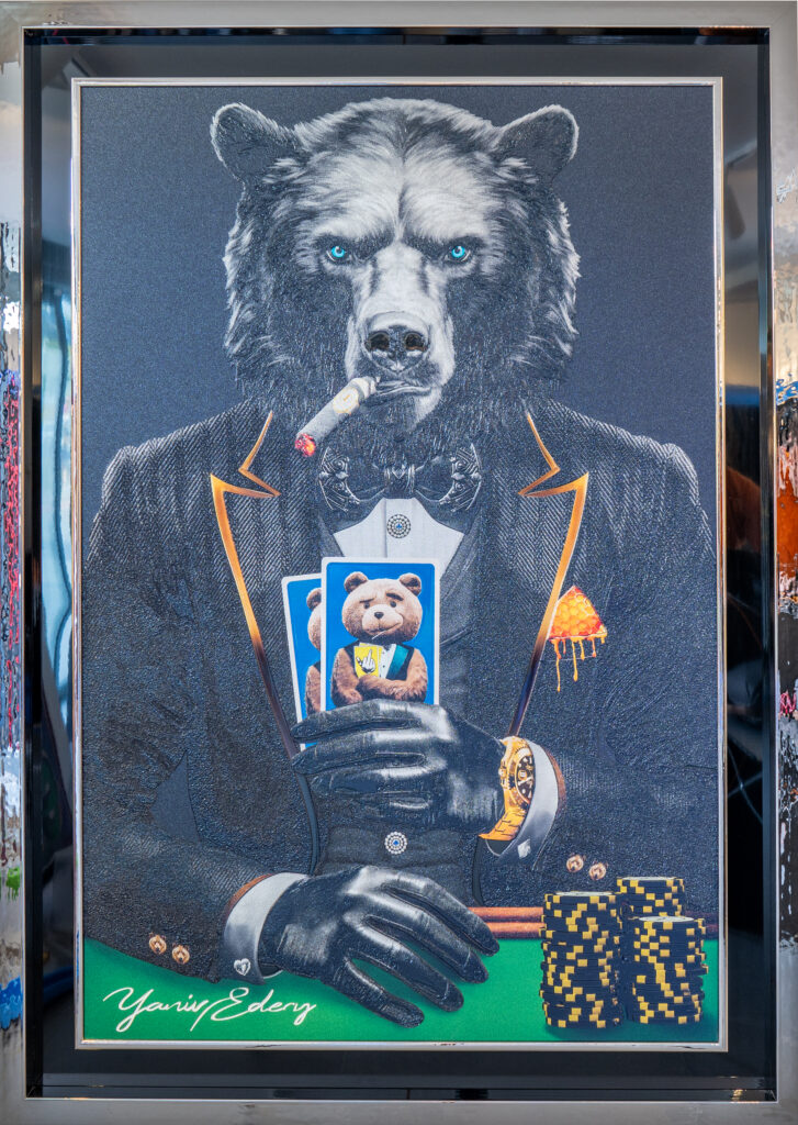 Yaniv Edery – Bear Pok'Art Grey Suit Bear Pok'Art van Yaniv Edery combineert kracht, mysterie en luxe. Een indrukwekkende beer, gehuld in een elegant grijs kostuum, zit zelfverzekerd aan de pokertafel. Met een sigaar in de mond en kaarten stevig in de hand straalt hij autoriteit en strategie uit. Zijn doordringende blauwe ogen trekken direct de aandacht en geven het werk een intense uitstraling. De verfijnde details in het pak, de glans van het horloge en de stapel fiches versterken het thema van macht en spel. De kaarten, waarop een teddybeer verschijnt, voegen een speels contrast toe. Dit maakt het werk verrassend en gelaagd. Het gaat niet alleen om het spel, maar ook om durf, bluffen en balans tussen kracht en kwetsbaarheid. Het kleurenpalet van grijs, zwart en subtiele accenten van goud creëert een luxueuze sfeer. Dit contrast benadrukt de spanning tussen elegantie en rauwe kracht. Het kunstwerk blijft fascineren omdat het telkens nieuwe details en betekenissen onthult. Plaats Bear Pok'Art Grey Suit in een woonkamer, kantoor of galerie en ervaar hoe het onmiddellijk een sterke en stijlvolle energie oproept. Het is niet zomaar een decoratie, maar een statement dat lef, humor en kracht combineert. Perfect voor wie houdt van moderne kunst met een twist.