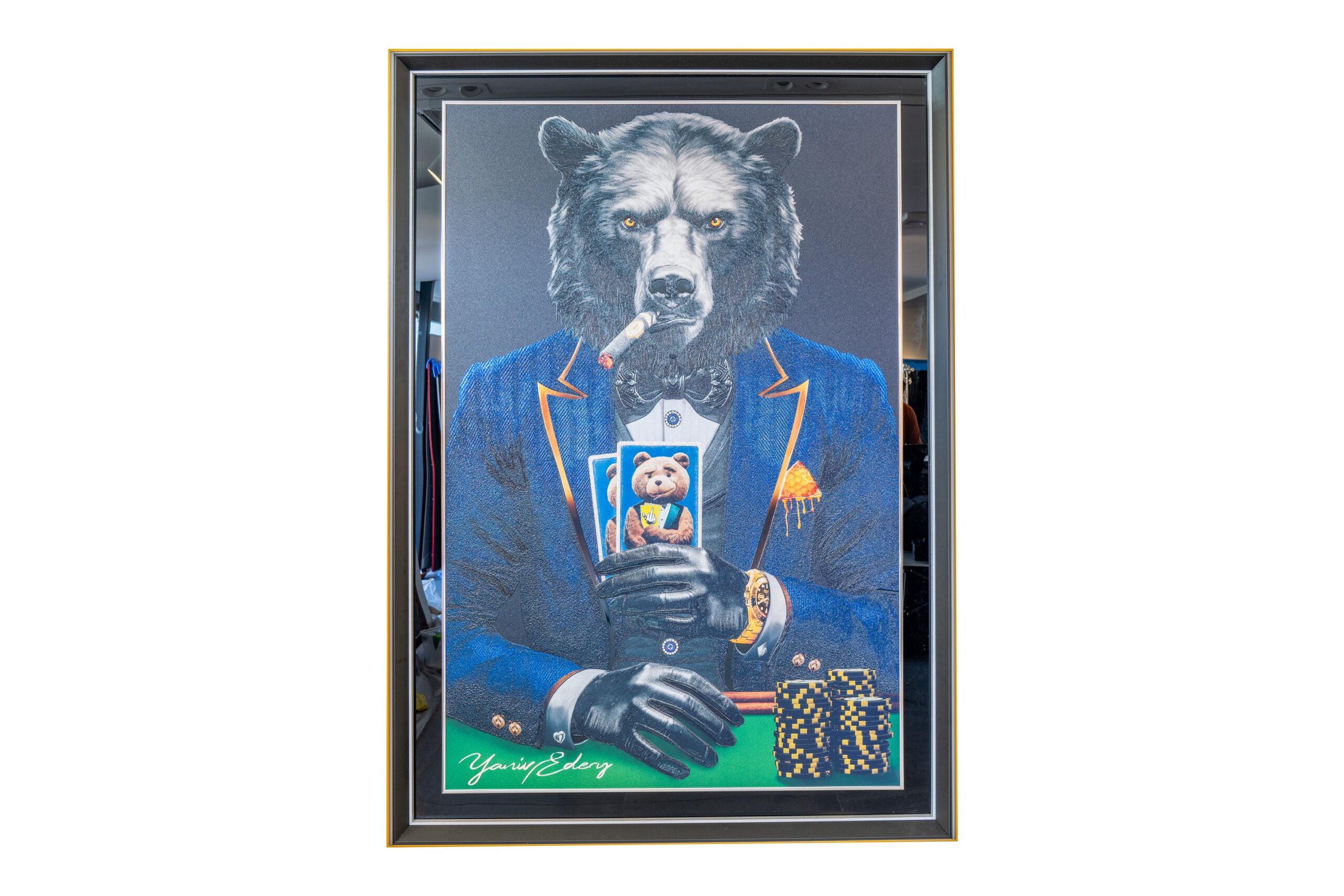 Yaniv Edery – Bear Pok’Art Blue Suit is een kunstwerk dat kracht, mystiek en luxe uitstraalt. De trotse beer zit stevig aan de pokertafel, gekleed in een stijlvol blauw pak met verfijnde oranje accenten. Zijn intense blik en strakke houding geven direct een gevoel van controle en vastberadenheid. Dit werk combineert elegantie met de rauwe energie van een roofdier. De beer rookt een sigaar en houdt zijn kaarten dicht bij zich. Hij straalt zelfvertrouwen en kalmte uit, precies zoals een winnaar zich gedraagt. De chips en gouden details versterken de sfeer van luxe en macht. Het is een spel van risico en beloning, maar ook van houding en charisma. Het blauwe pak speelt hierin een centrale rol. Blauw staat symbool voor betrouwbaarheid, kracht en wijsheid. Door dit te combineren met de onverschrokken beer ontstaat er een unieke harmonie tussen stijl en natuurkracht. Elk detail, van de textuur van de vacht tot de scherpe lijnen van het pak, is zorgvuldig uitgewerkt. Dit kunstwerk vertelt meer dan alleen een verhaal over poker. Het gaat over strategie, kracht en de kunst om emoties te beheersen. Net zoals in poker is in het leven balans tussen lef en bedachtzaamheid essentieel. De beer belichaamt precies dat: een meester van kracht en kalmte. Bear Pok’Art Blue Suit is niet zomaar een kunstwerk. Het is een statement. Een krachtige toevoeging aan elke ruimte. Een kunstwerk dat blijft boeien, uitdagen en inspireren.